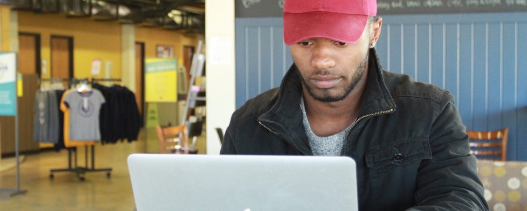 Student on laptop in student center | Point University