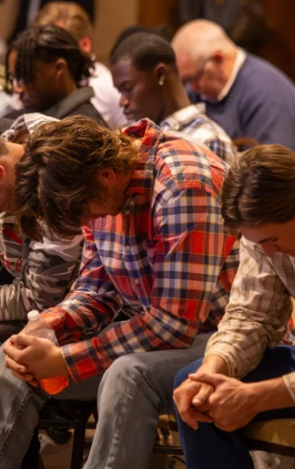 students praying in crowd