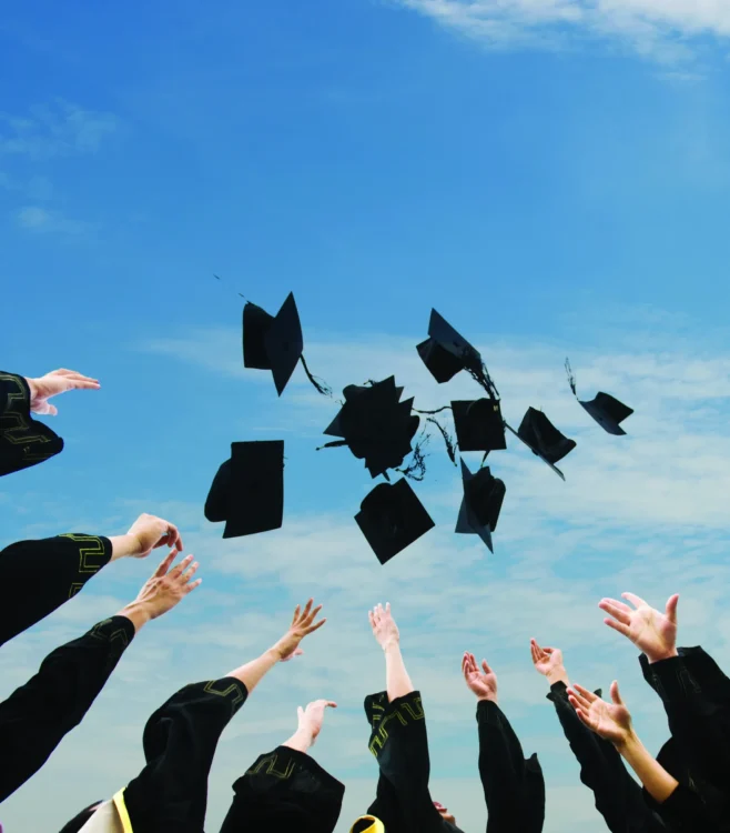 graduation caps flying in the air