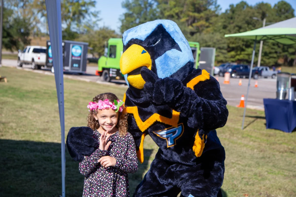 point mascot with child at game parking lot