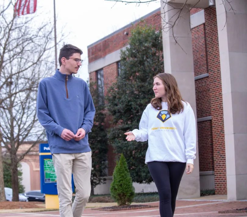 students walking outside on campus