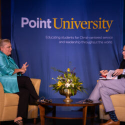 Point University stage with 2 people discussing book