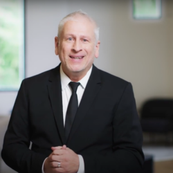 person in black suit at point