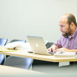 person at desk with computer