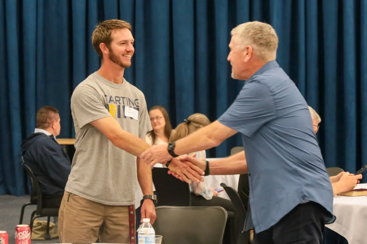 Student shaking hands with Jim Donovan