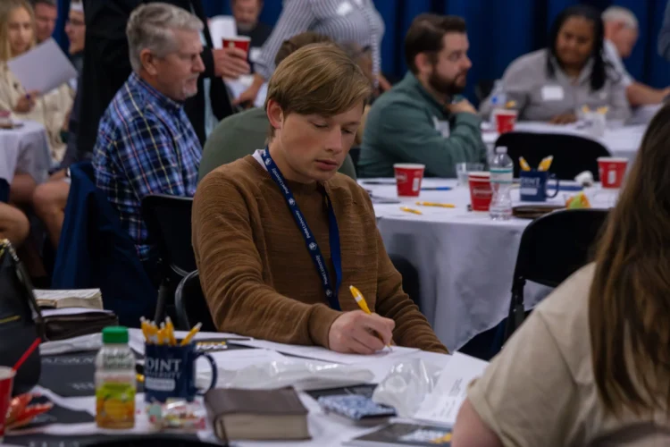 Student taking notes at the Pursue Ministry Conference
