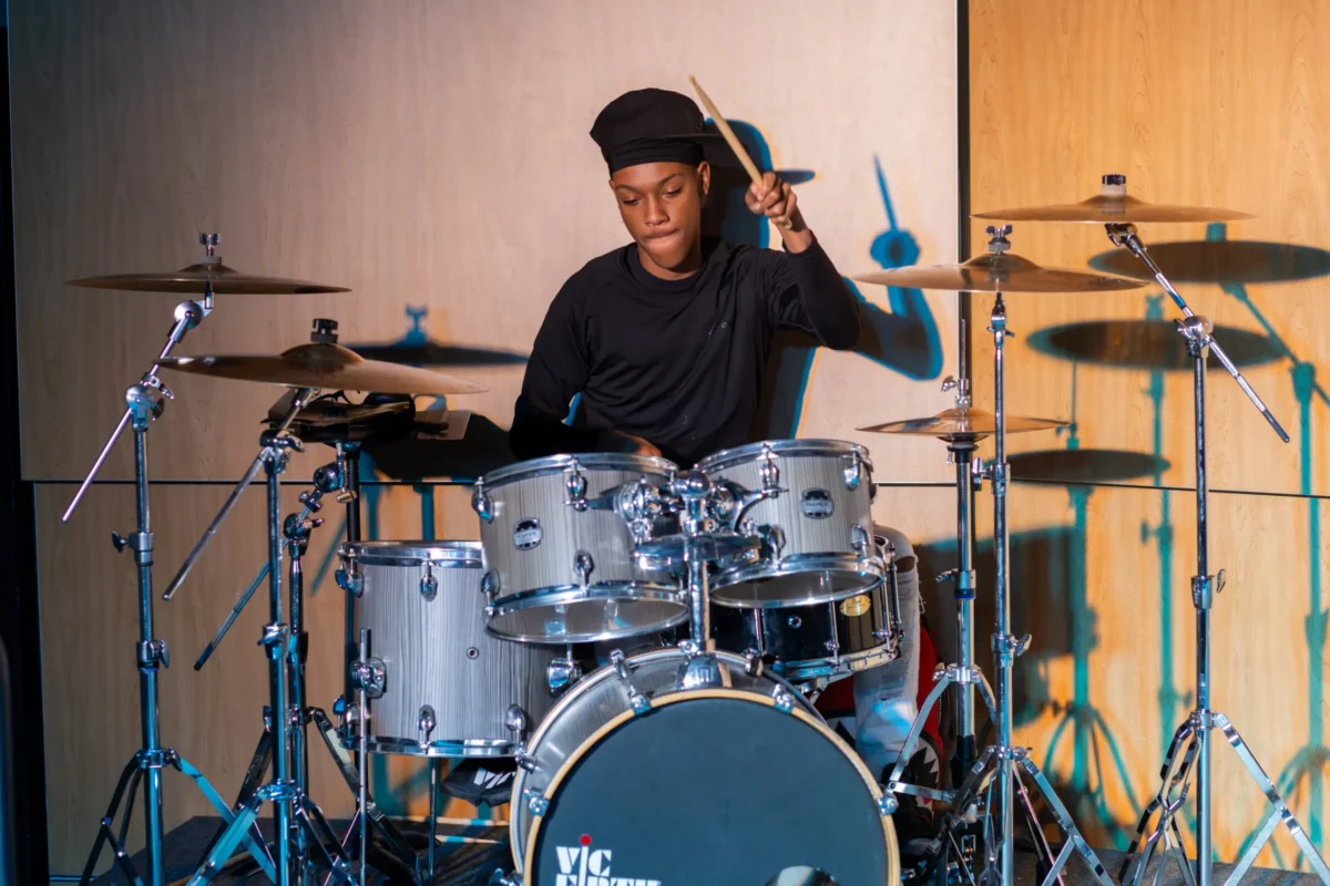 Student playing drums in the Fine Arts